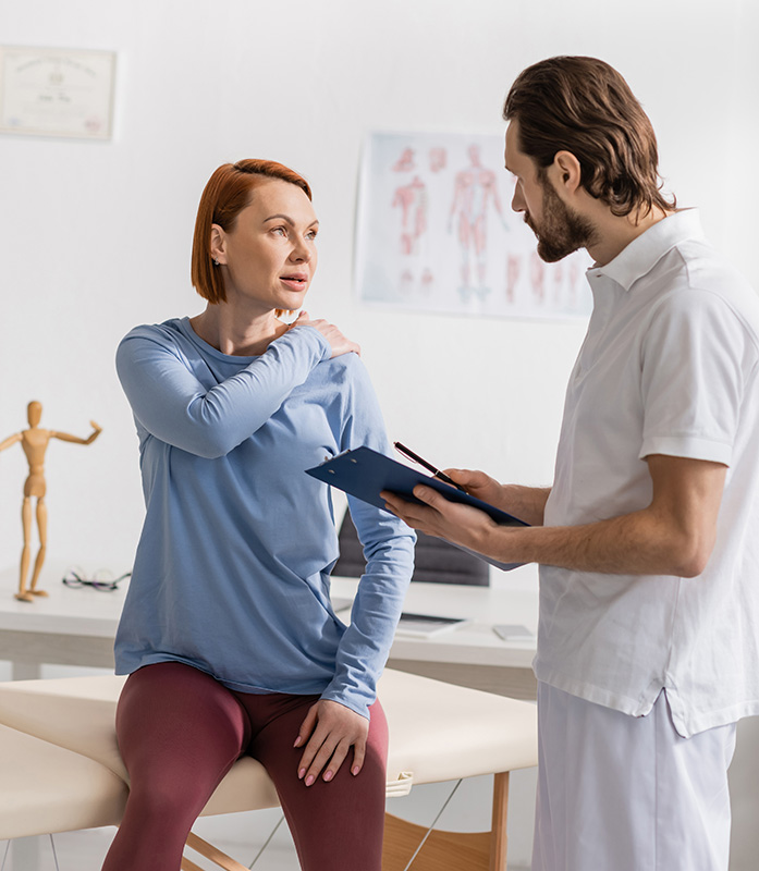 Massage therapist giving an initial consultation to find out the patients specific needs.